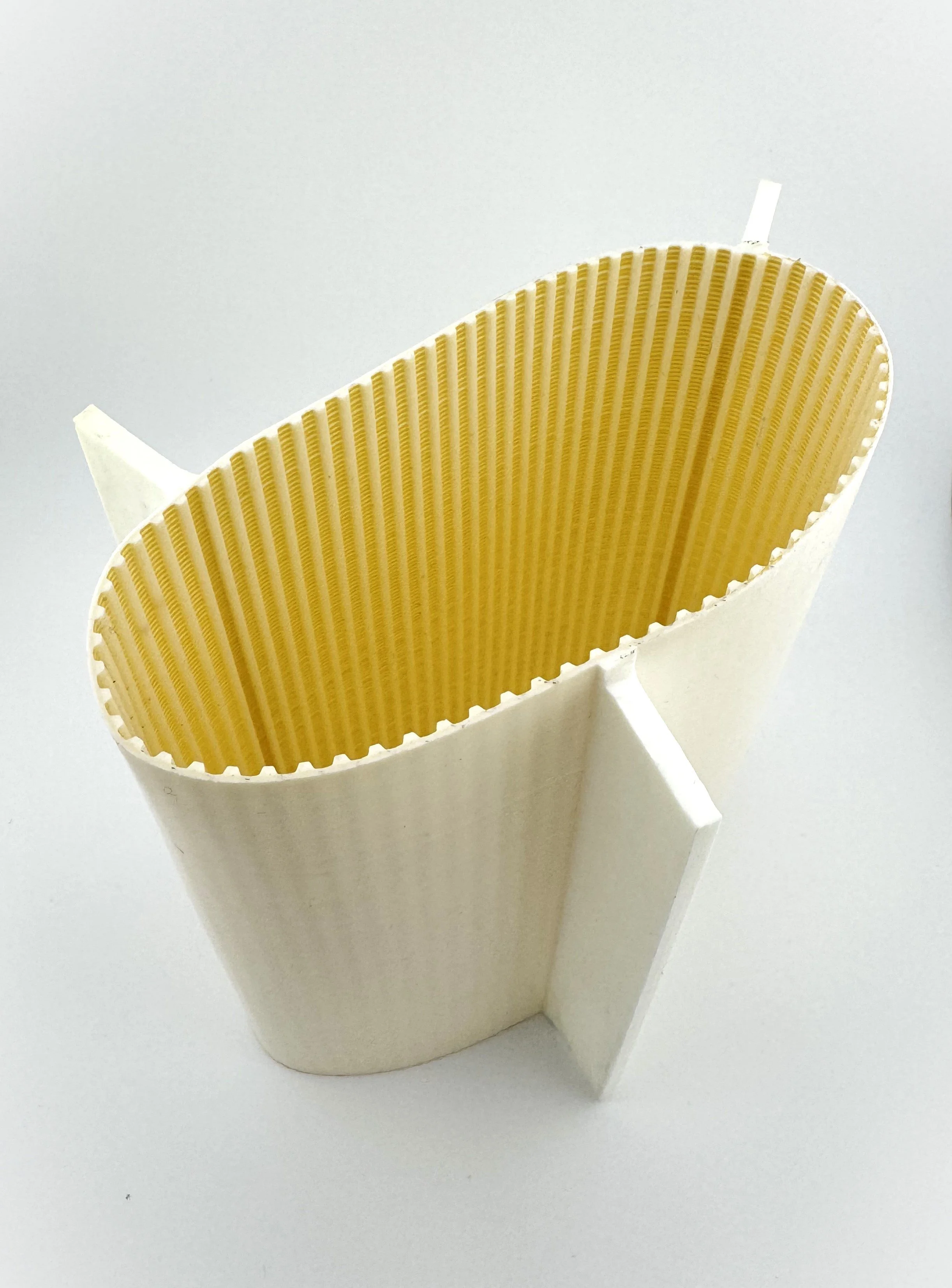 A partly opened rectangular egg carton made of foam, with empty yellow egg compartments visible inside.