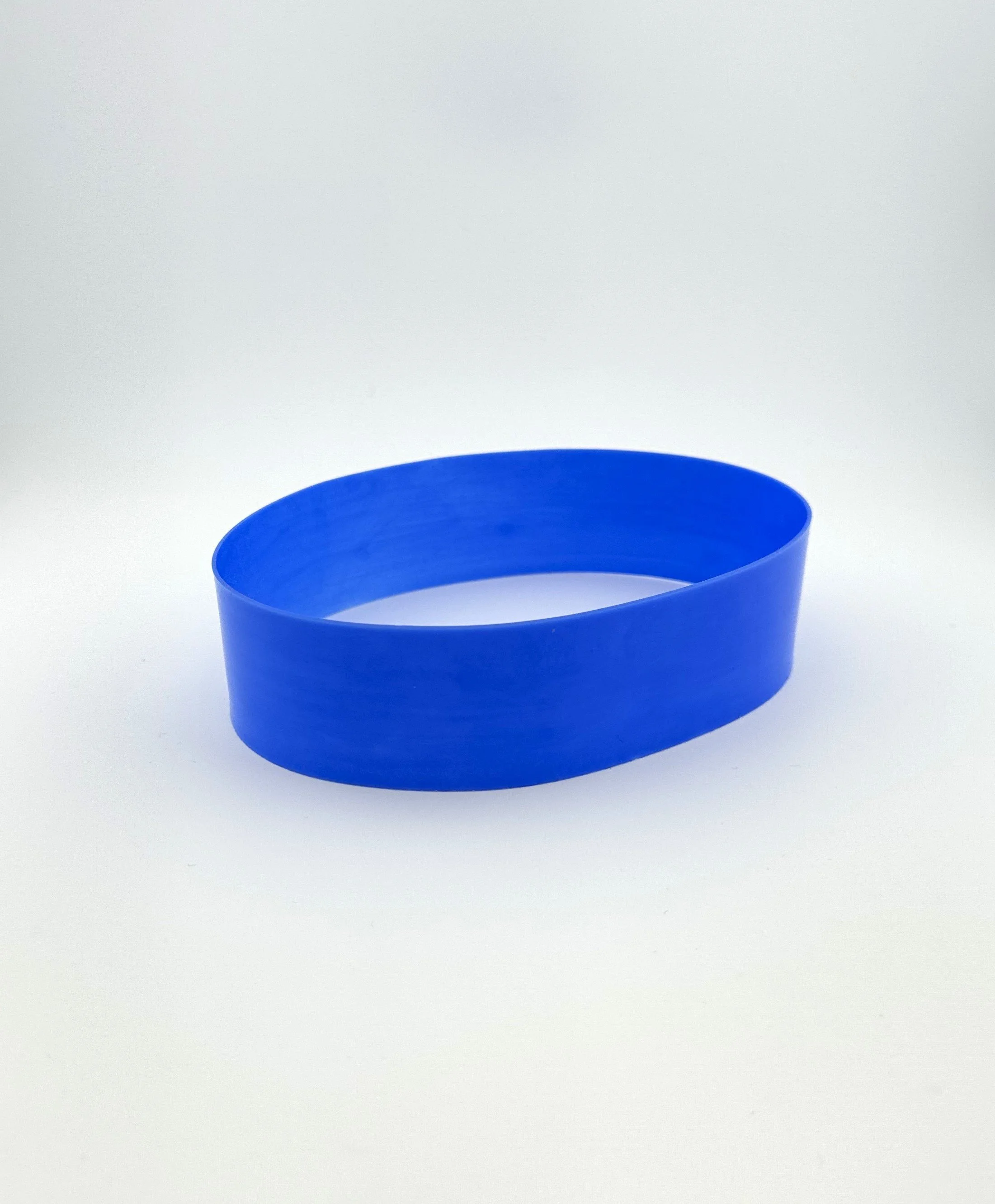 A blue rubber wristband on a white surface.