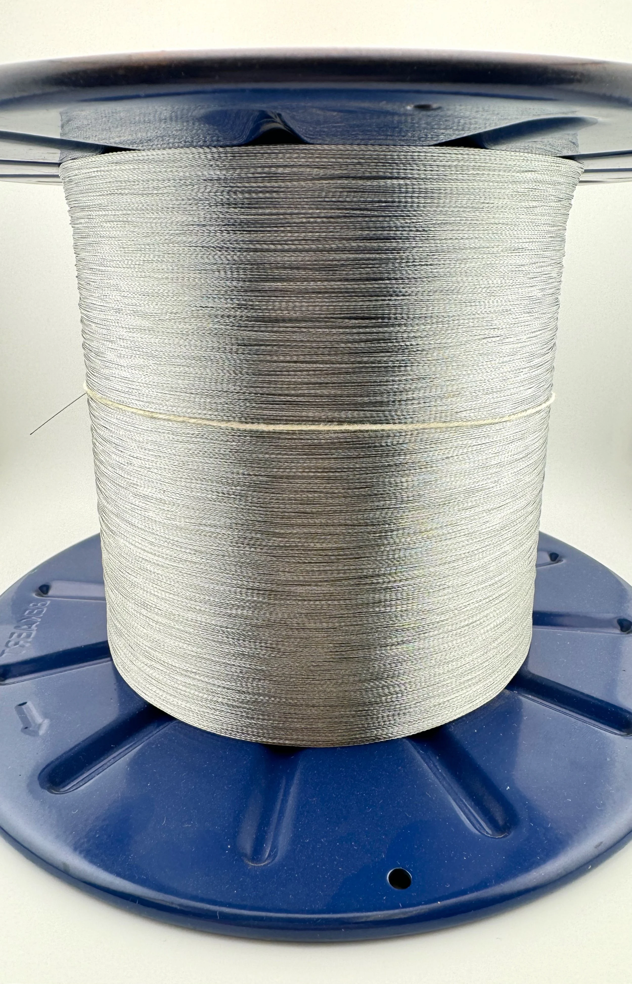 Spool of metallic filament on a blue plastic reel.